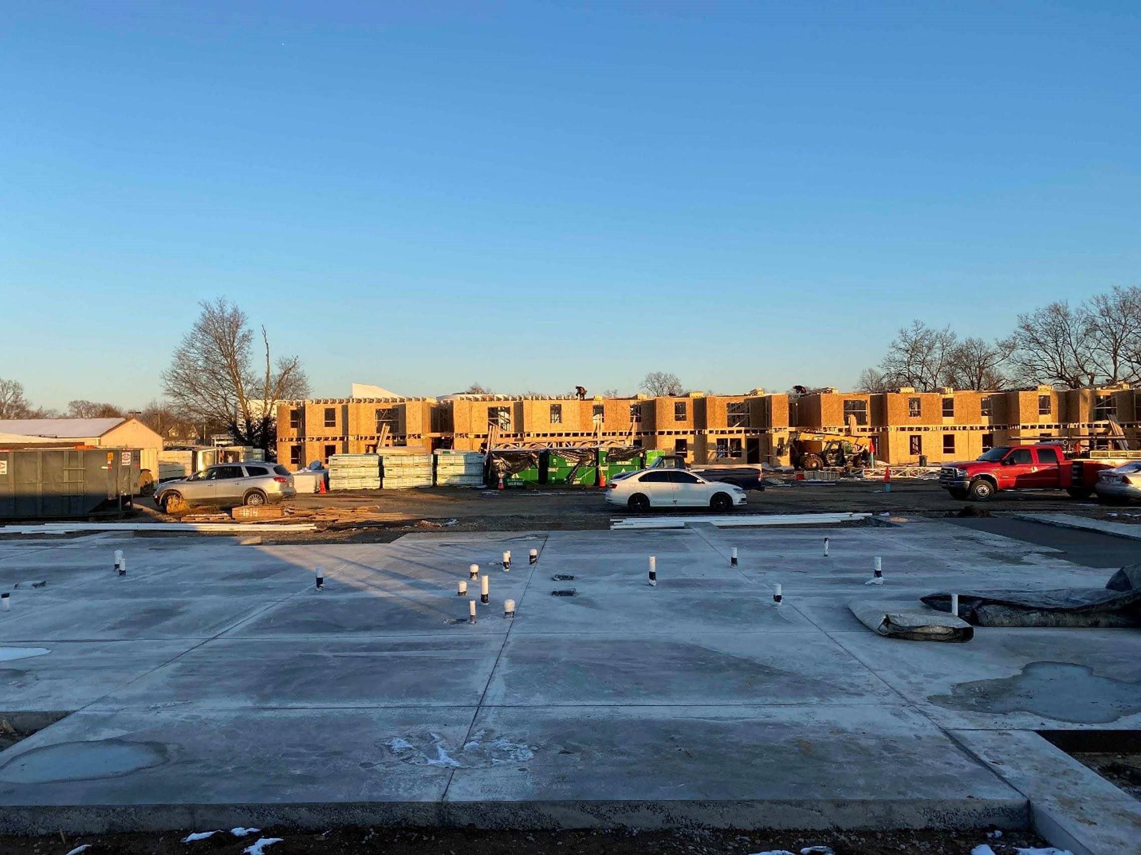 a view of a parking lot with apartments in the background